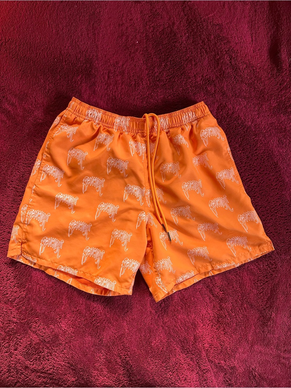 Revenge Clothing Orange Athletic Shorts with All Over Revenge Arch Logo Print